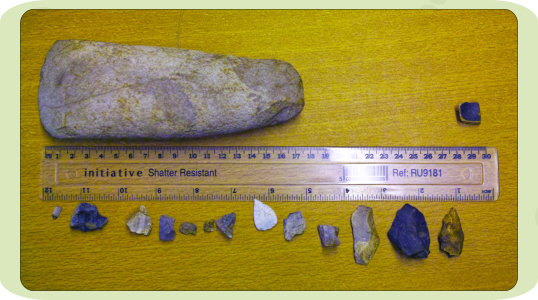 The large hand-axe is of polished limestone, the lower tools are of chert and flint